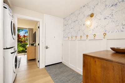 The entrance to your condo on the main floor provides easy access to the first guest bedroom, washer and dryer, as well as the main living space and kitchen.