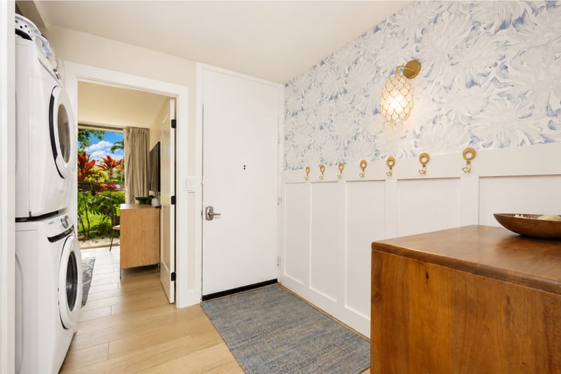 The entrance to your condo on the main floor provides easy access to the first guest bedroom, washer and dryer, as well as the main living space and kitchen. KUL-W11