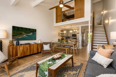 Your open-concept living room blends comfort and style with vaulted ceilings and indoor-outdoor flow.