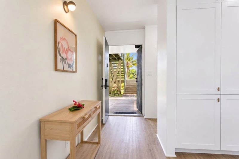 Entry at Kuilima West Estates 144, with ground-floor access and exterior stairs leading to the front door.