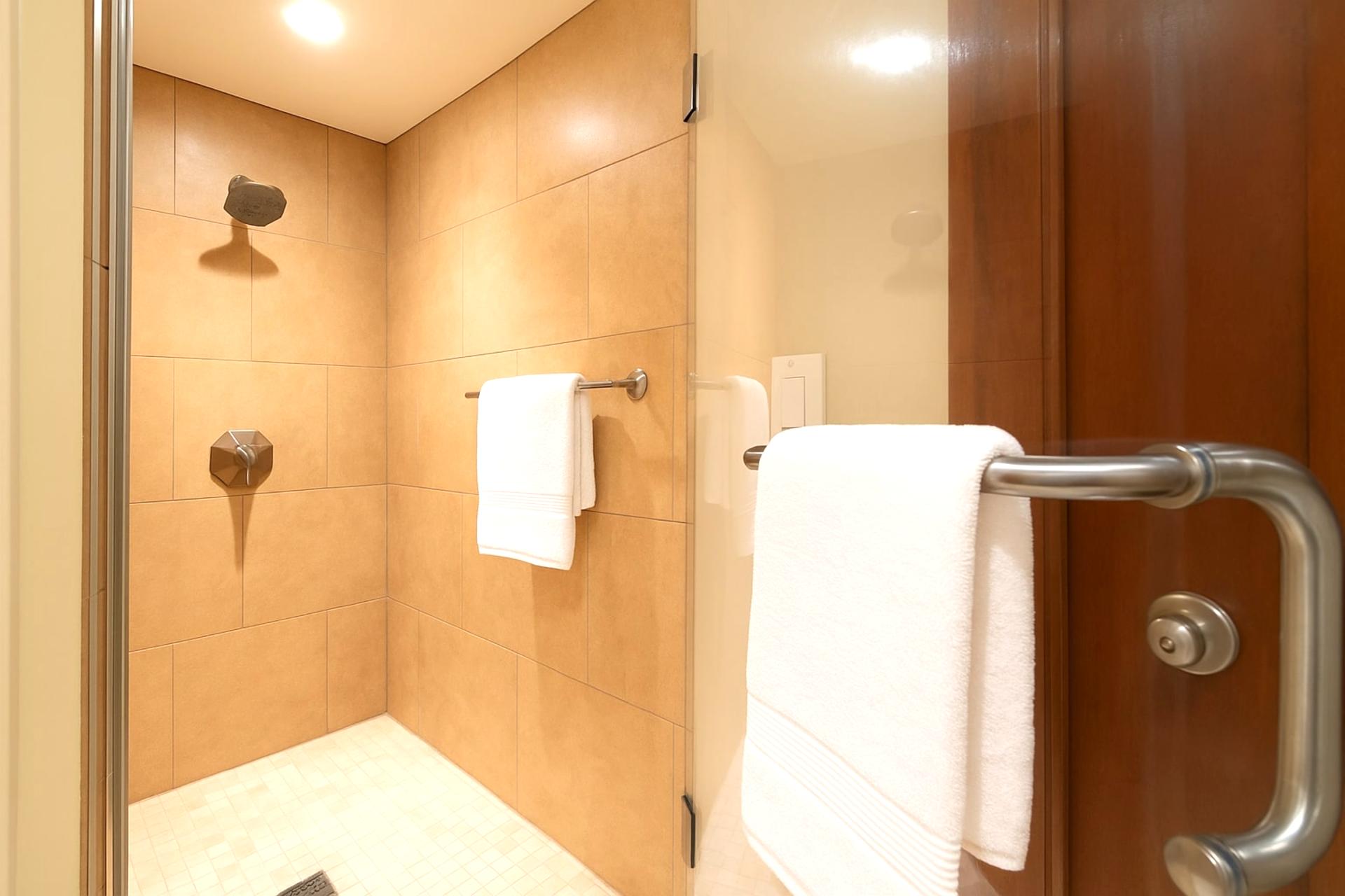 Enjoy the soothing rhythm of the rainfall shower and wrap yourself in luxury after a day of sun, surf, and serenity    