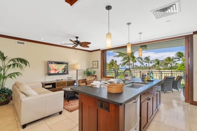 Crisp cream couches, a breezy balcony, and a kitchen close enough to keep the mai tais flowing all day long