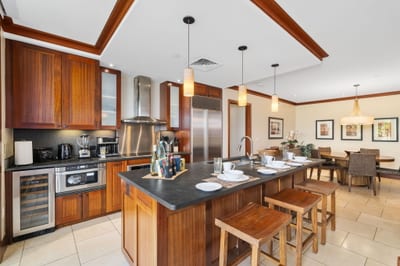 Warm wood tones meet modern luxury in this spacious kitchen—ideal for big breakfasts or sunset wine prep