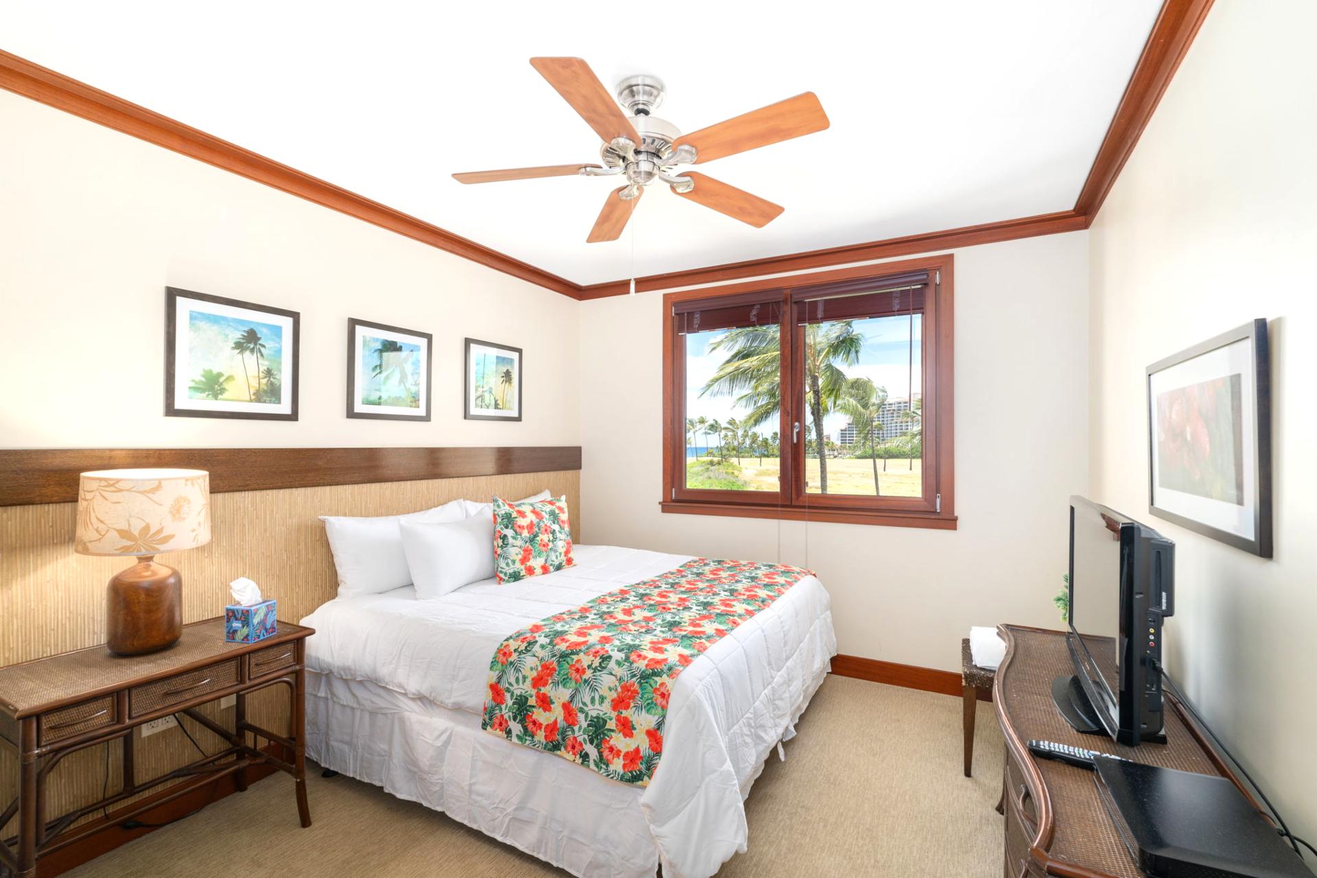 Fall asleep in a cozy Queen bed with hibiscus blooms at your side and palm trees waving hello just outside your window    