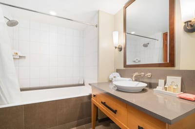 Unwind in the oversized tub or step into the glass-walled shower—this master bath is built for calm and comfort
