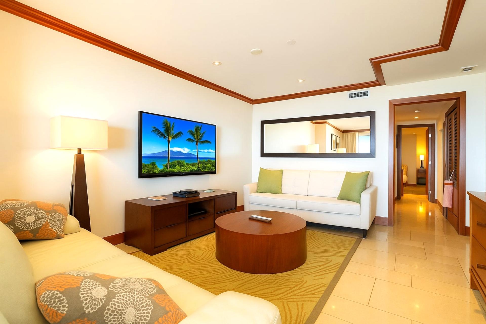 Crisp corners and curved tables create harmony, while the rug whispers of beach walks and flip-flop footprints