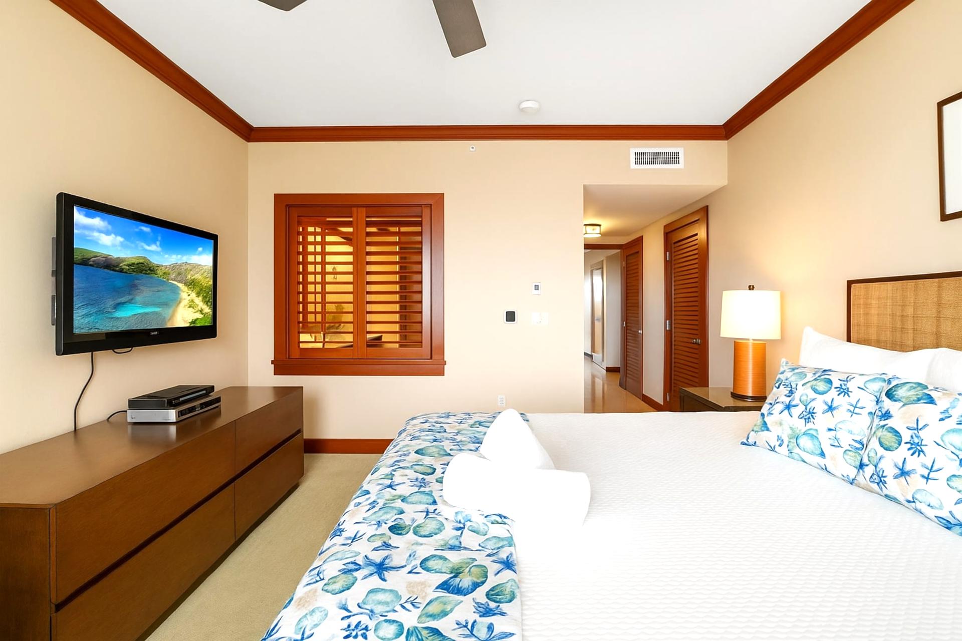 Sleek wood dressers and earthy tones bring serene balance, grounding the plush grandeur of the king-sized haven