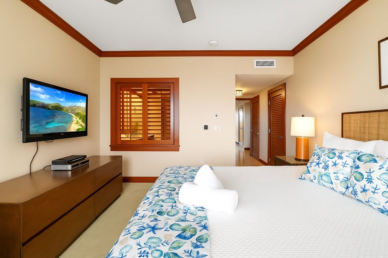 Sleek wood dressers and earthy tones bring serene balance, grounding the plush grandeur of the king-sized haven