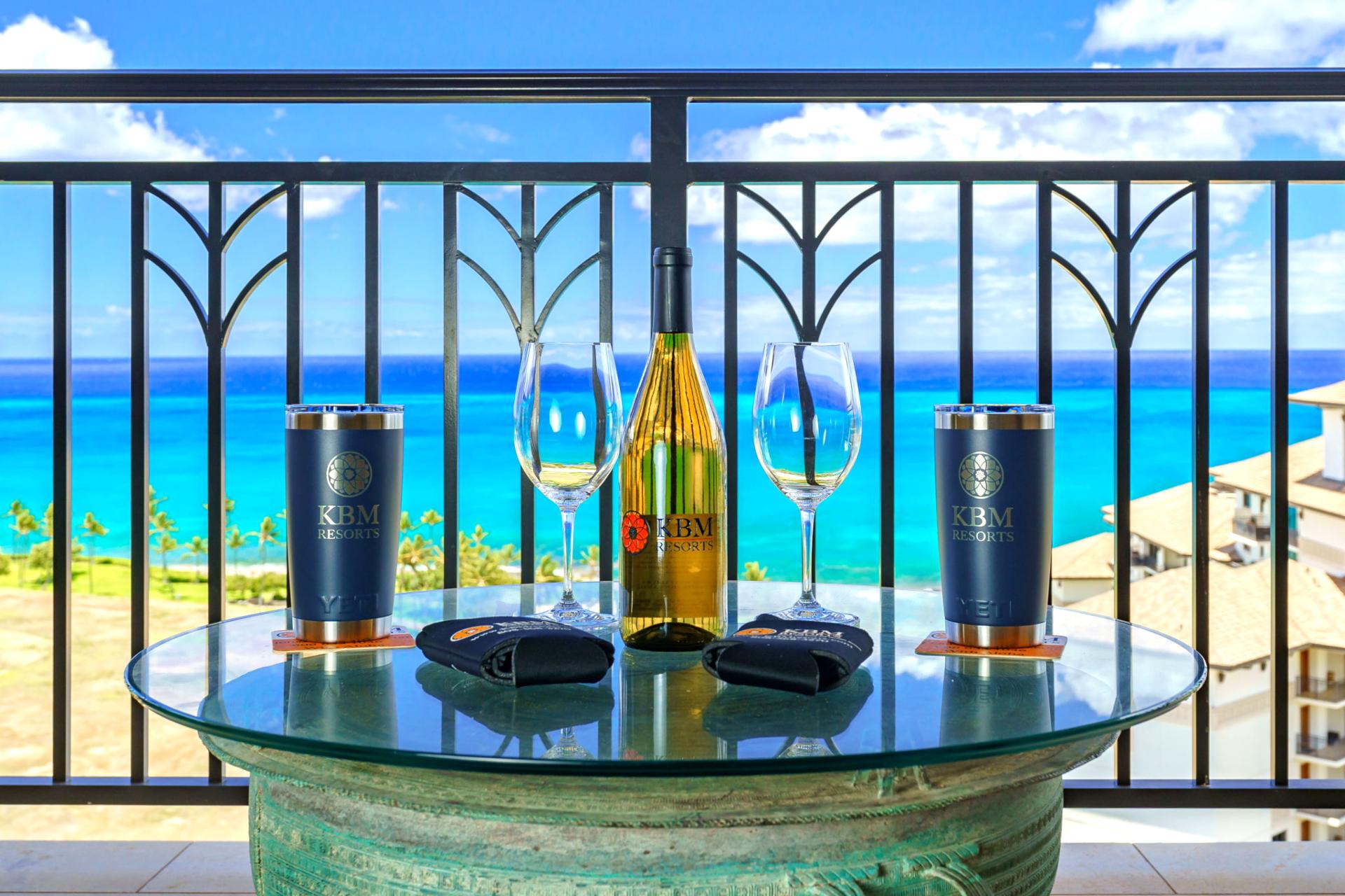 Every detail sets the scene—from custom tumblers to a bottle of wine—all against the turquoise canvas of the sea    