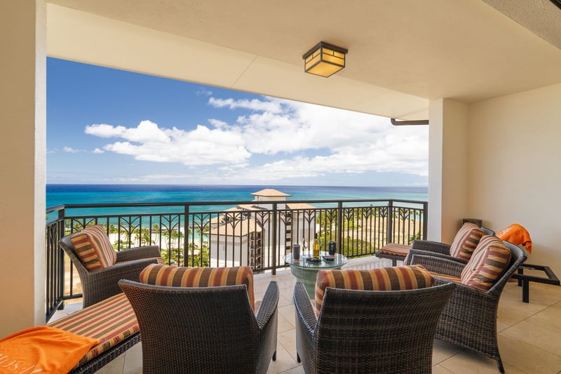 With stripe-clad chairs and ocean-stretched views, this lanai feels like a beach club in the sky—minus the crowds    
