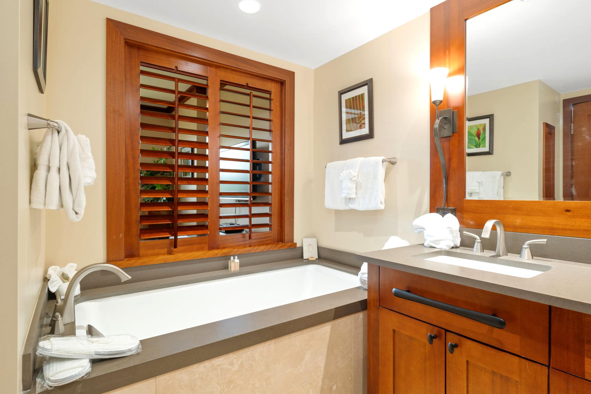 Soak under soft lighting in a tub with a view—those shuttered windows aren't just pretty, they’re peekaboo perfection    