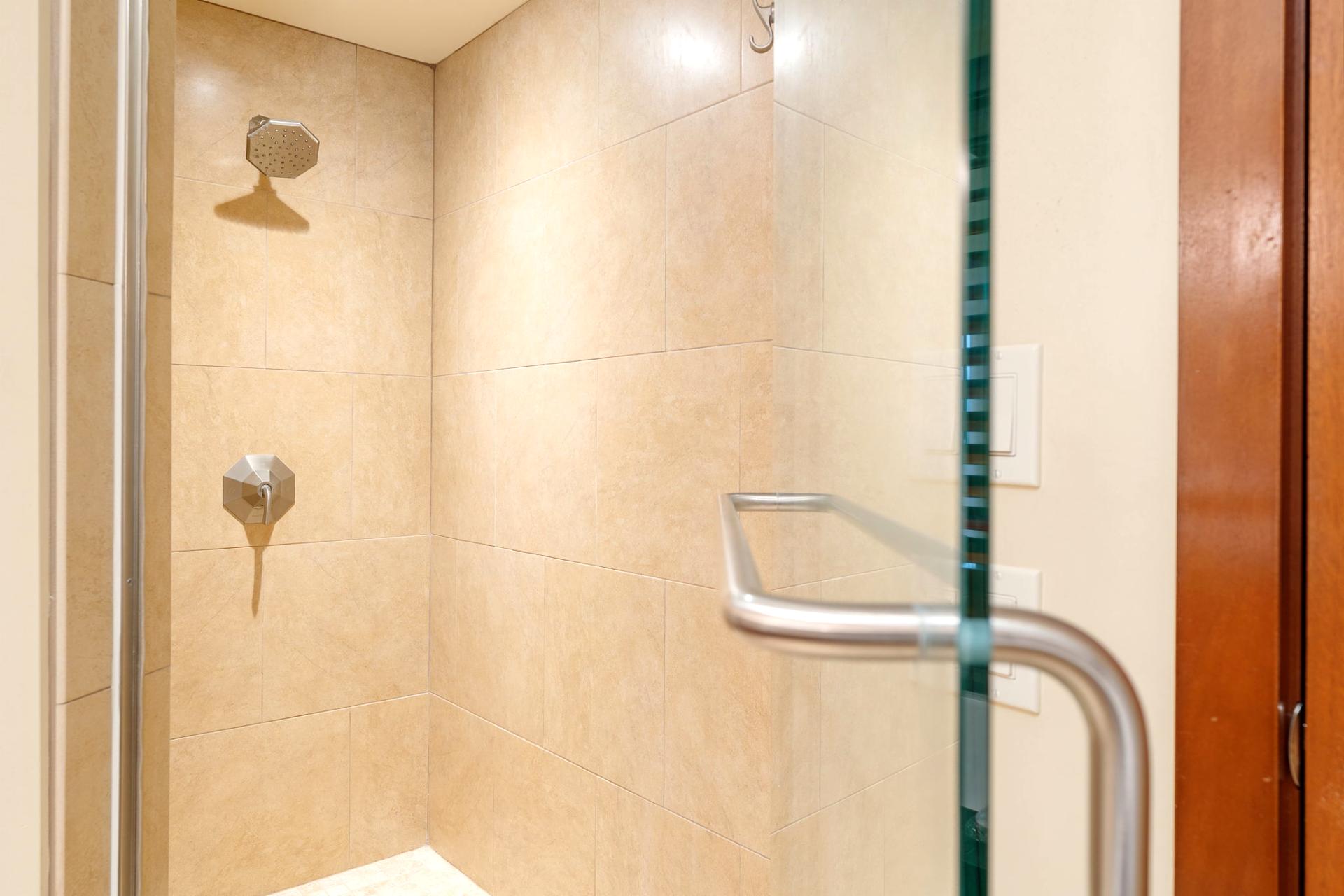  The walk-in shower stands ready like a sandstone throne room, awaiting its next royal rinse ceremony   