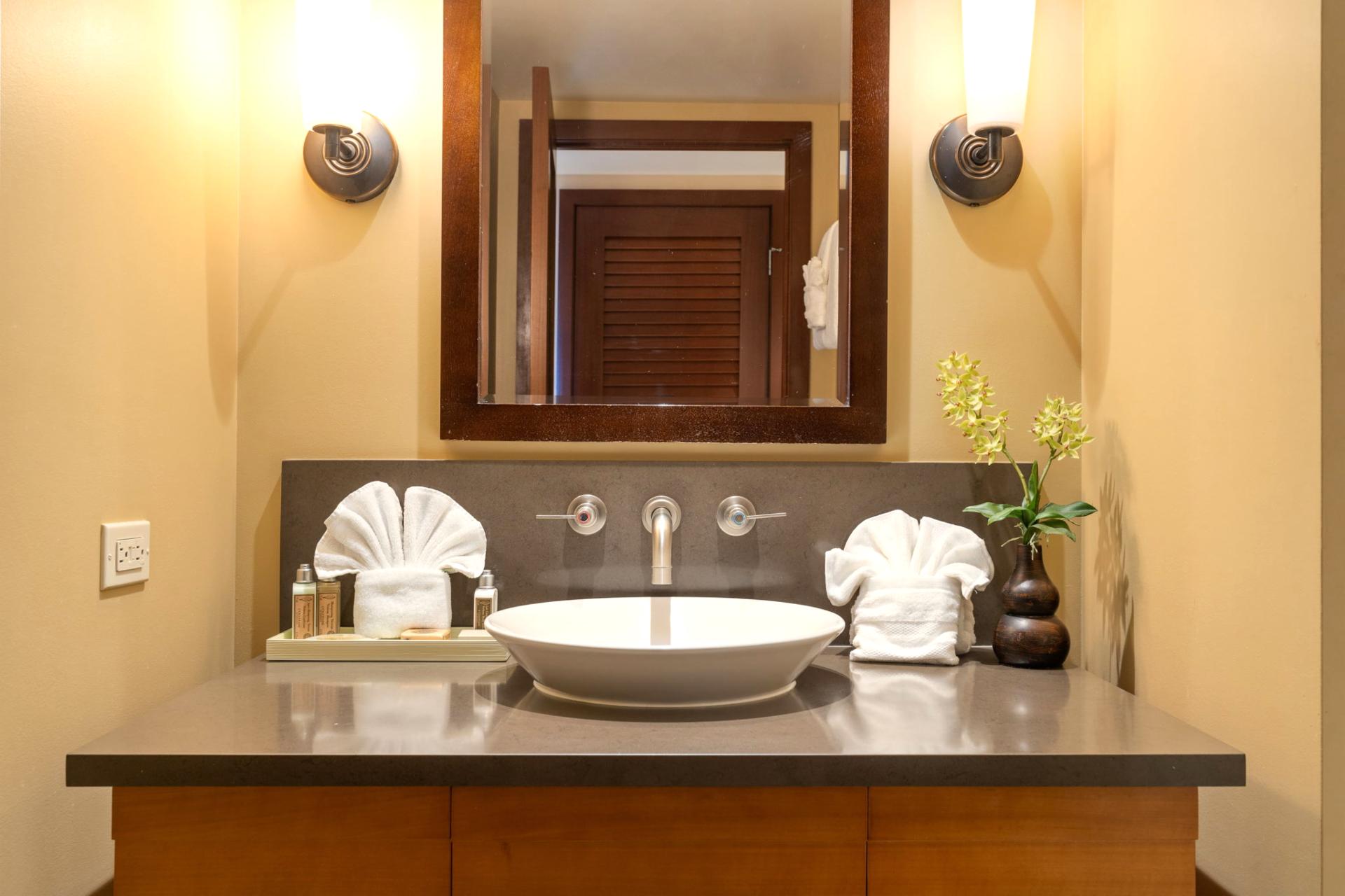 A sculpted vessel sink sits proudly atop its stone stage, ready to make your morning rinse feel utterly glamorous    