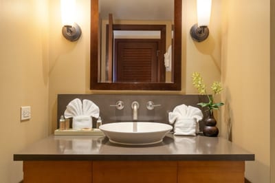 A sculpted vessel sink sits proudly atop its stone stage, ready to make your morning rinse feel utterly glamorous