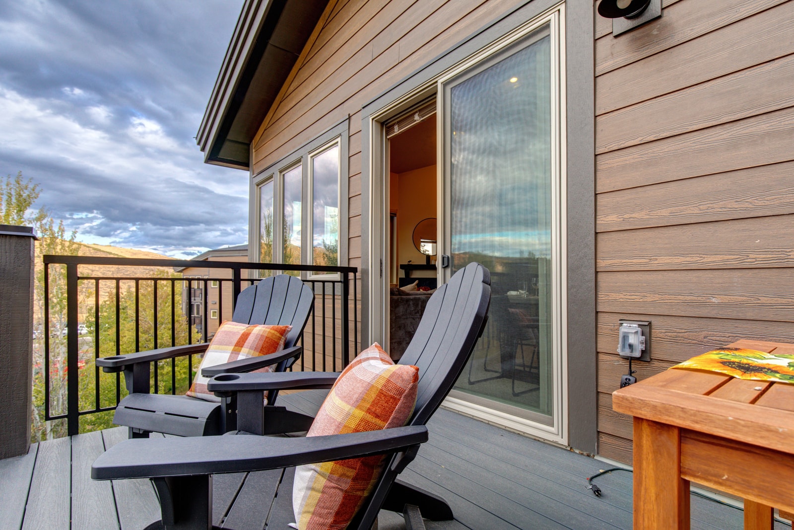 Lounge chairs and outdoor dining make this private deck an inviting extension of your living space.