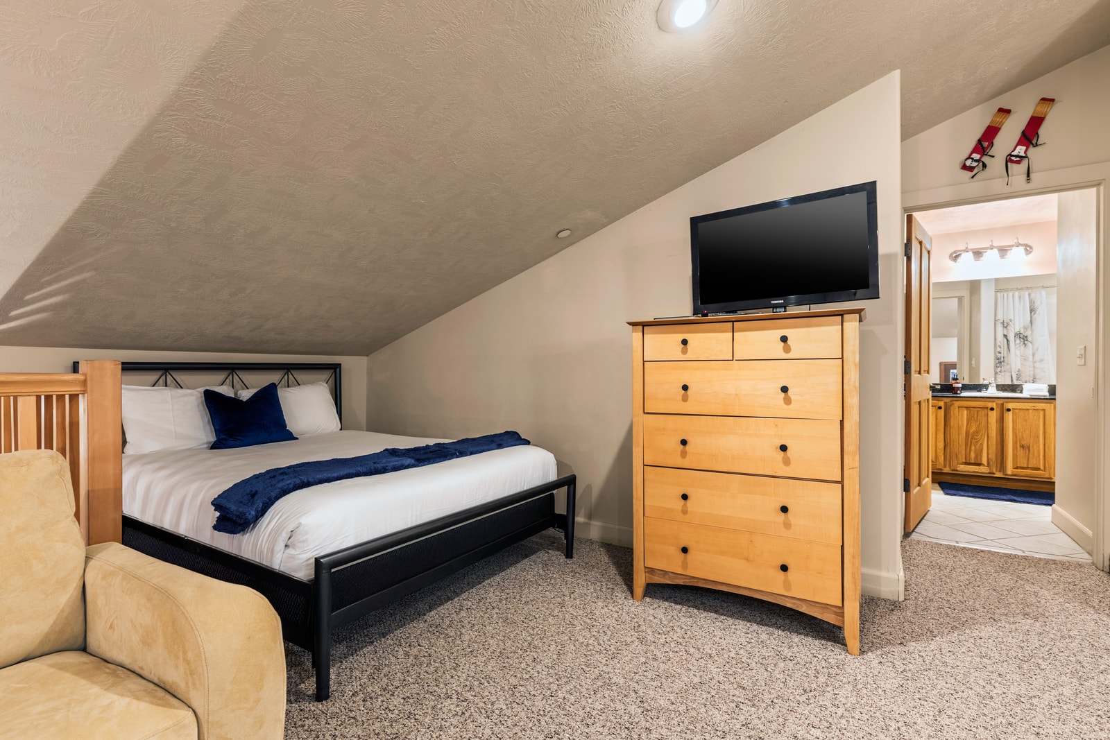 Upstairs loft bedroom features a Queen bed, TV, and two twin beds making it  perfect for a second couple or teens.