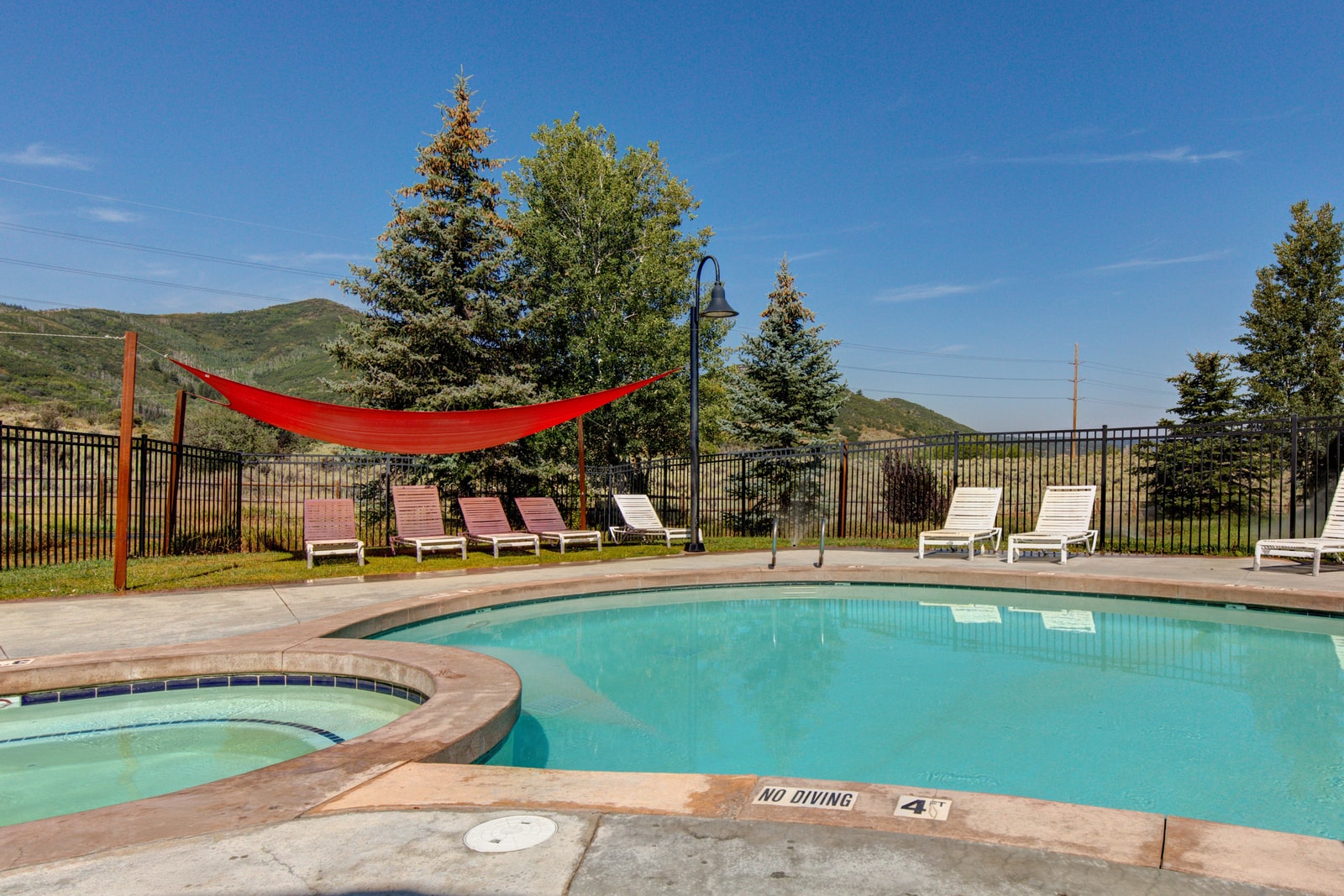 Enjoy access to the outdoor pool with mountain views and loungers for sunny relaxation.