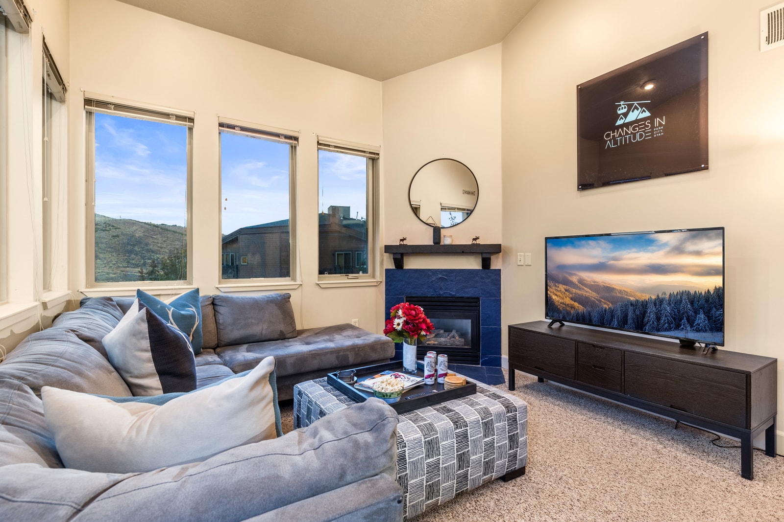 Wraparound windows and plush sectional seating make this living area a bright and cozy retreat.