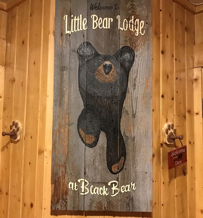 Welcome sign and rustic charm greet you at Black Bear Lodge’s main entry.
