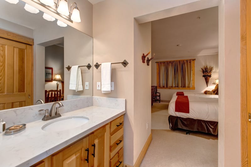 Guest bath includes dual sinks, granite counters, and access from the two-Queen bedroom.