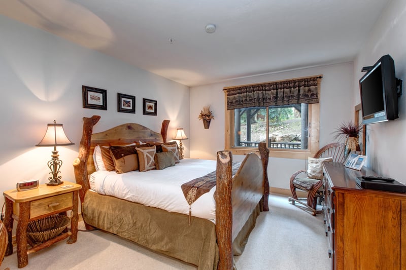 The primary bedroom offers a King bed, Smart TV, and direct access to a private ensuite bath.
