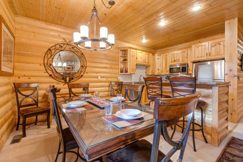 Dining table for six with rustic wood finishes and mountain-inspired lighting for cozy meals in.