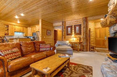 Fireside lounging with leather seating and a warm, inviting layout perfect for après-ski evenings.