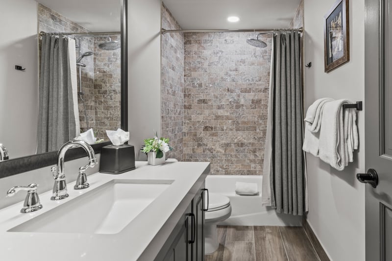 Refresh in this bright guest bath with counters and bathtub and shower combination