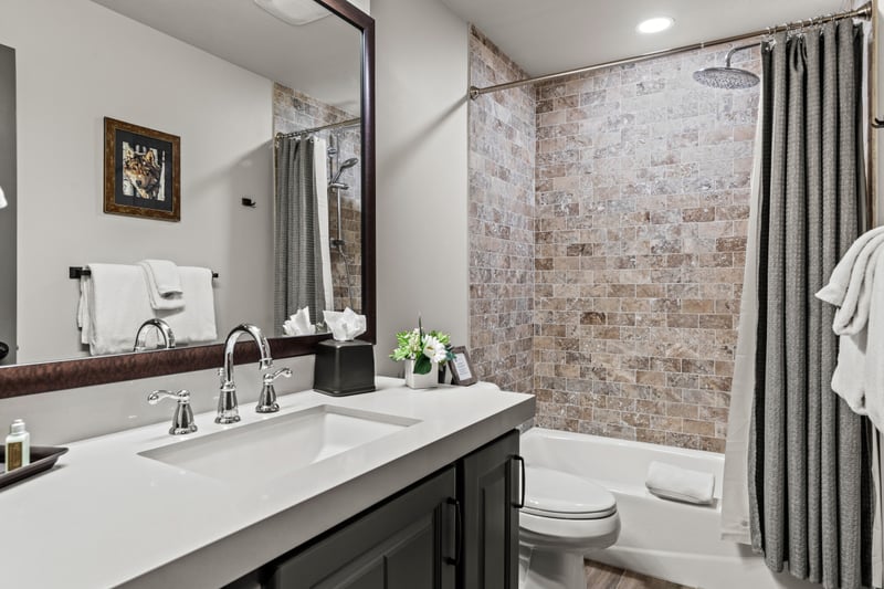 Your guest bath features a vanity and bath shower and tub