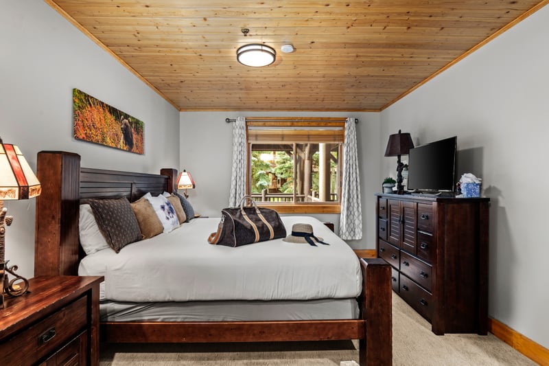 Guest bedroom features a King bed, flat-screen TV, and large window for natural light. BBL-351A