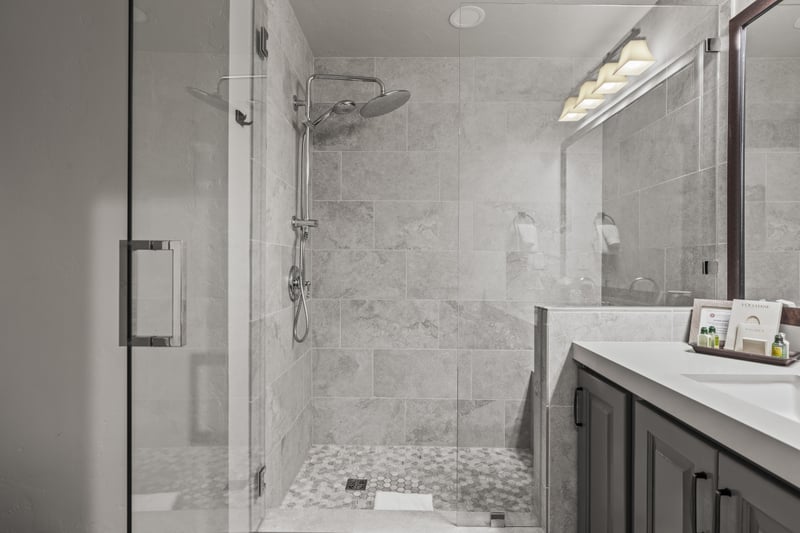 The guest bath with sleek tile and vanity offers comfort and privacy for your group.