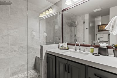 Enjoy an updated guest bath with a granite vanity and fresh, modern fixtures.