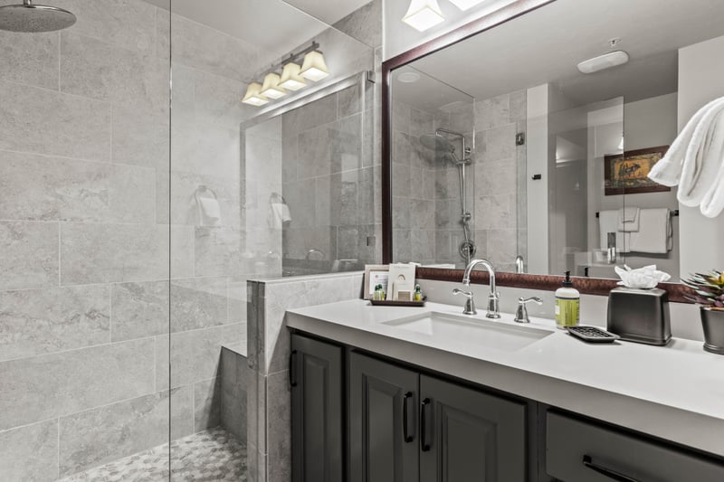 Enjoy an updated guest bath with a granite vanity and fresh, modern fixtures.