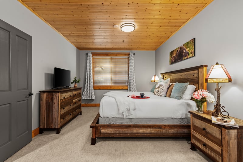 Bedroom includes a King bed, warm wood finishes, and ensuite bath access. BBL-351A