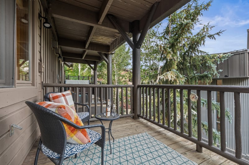 Your balcony offers a peaceful perch above the trees with seating for two and a view. BBL-351A