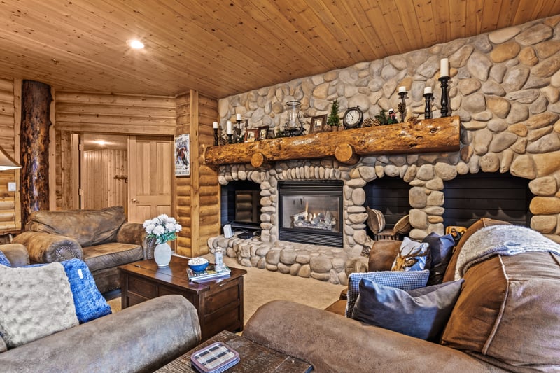 Unwind with your favorite beverages in the welcoming living room, complete with a stone fireplace and rustic wood beams. BBL-351A
