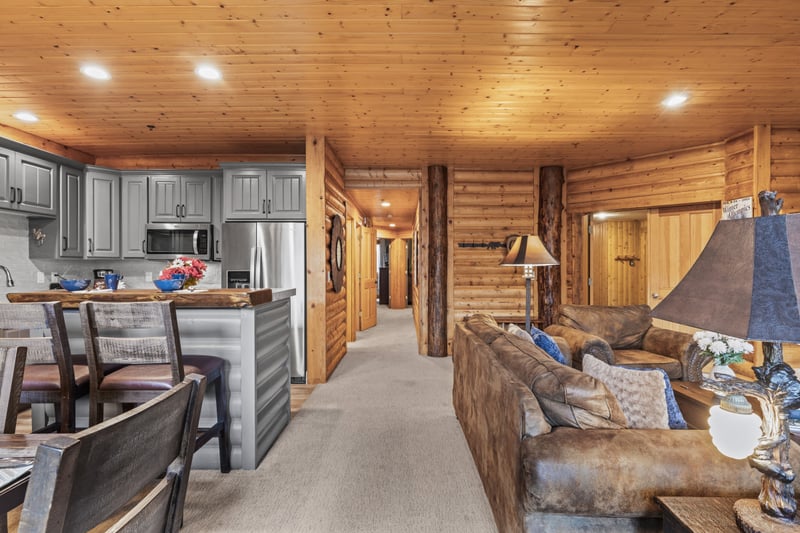 A stone fireplace and log accents add rustic character to the main living space. BBL-351A