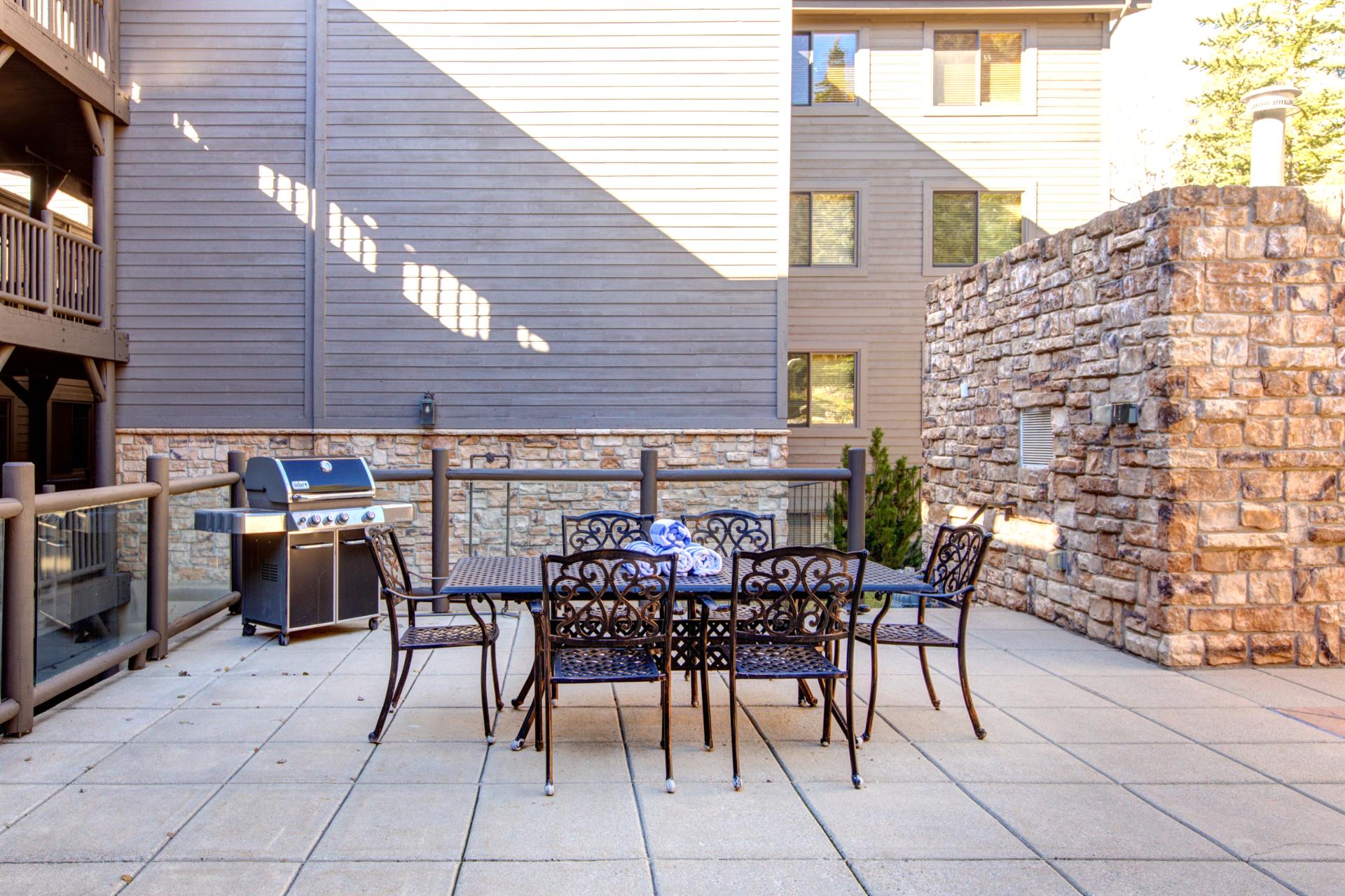 Spacious outdoor patio with grill and dining for gatherings.