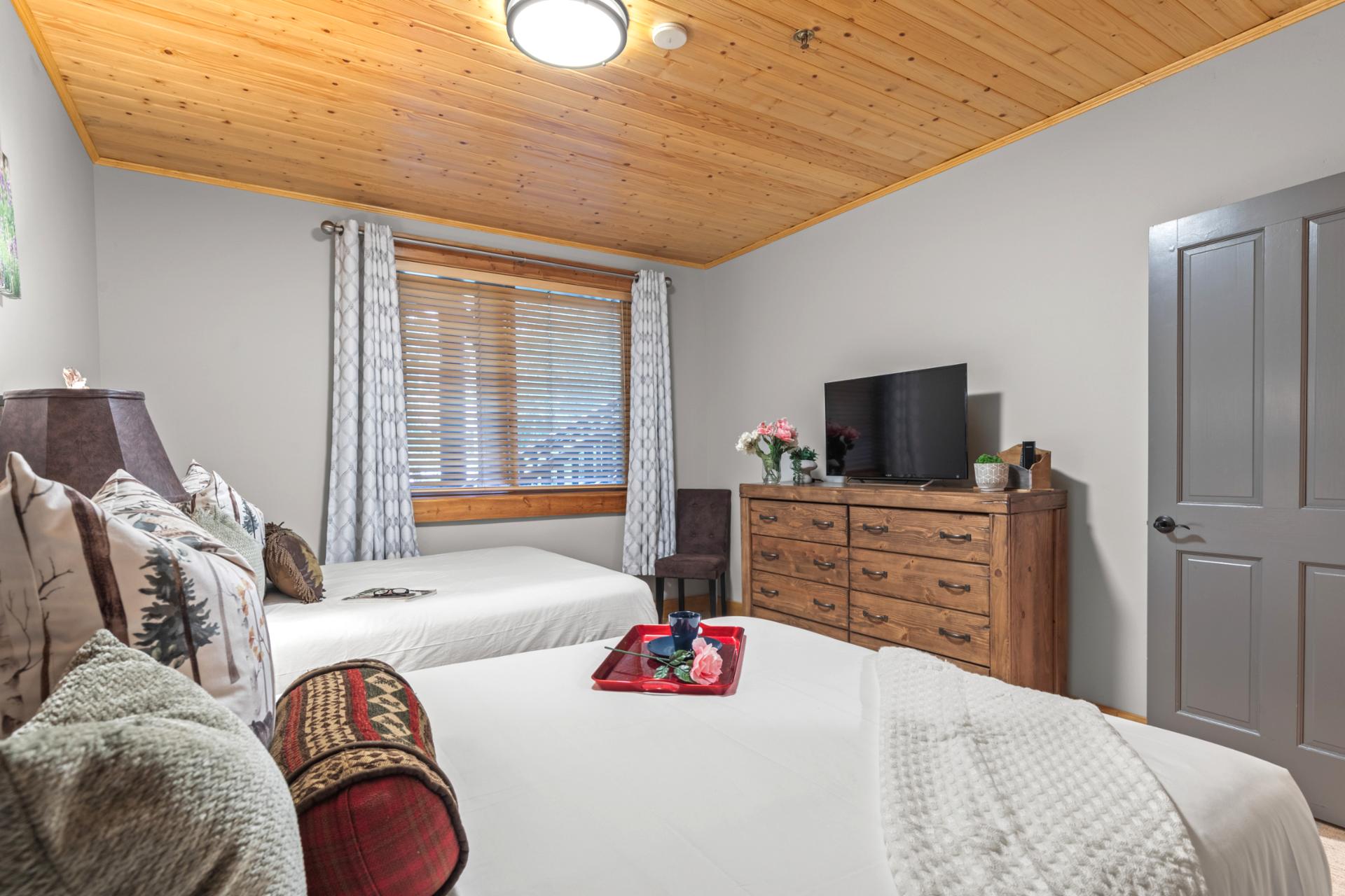 Relax in this spacious guest room with two Queen beds and lodge-inspired decor.