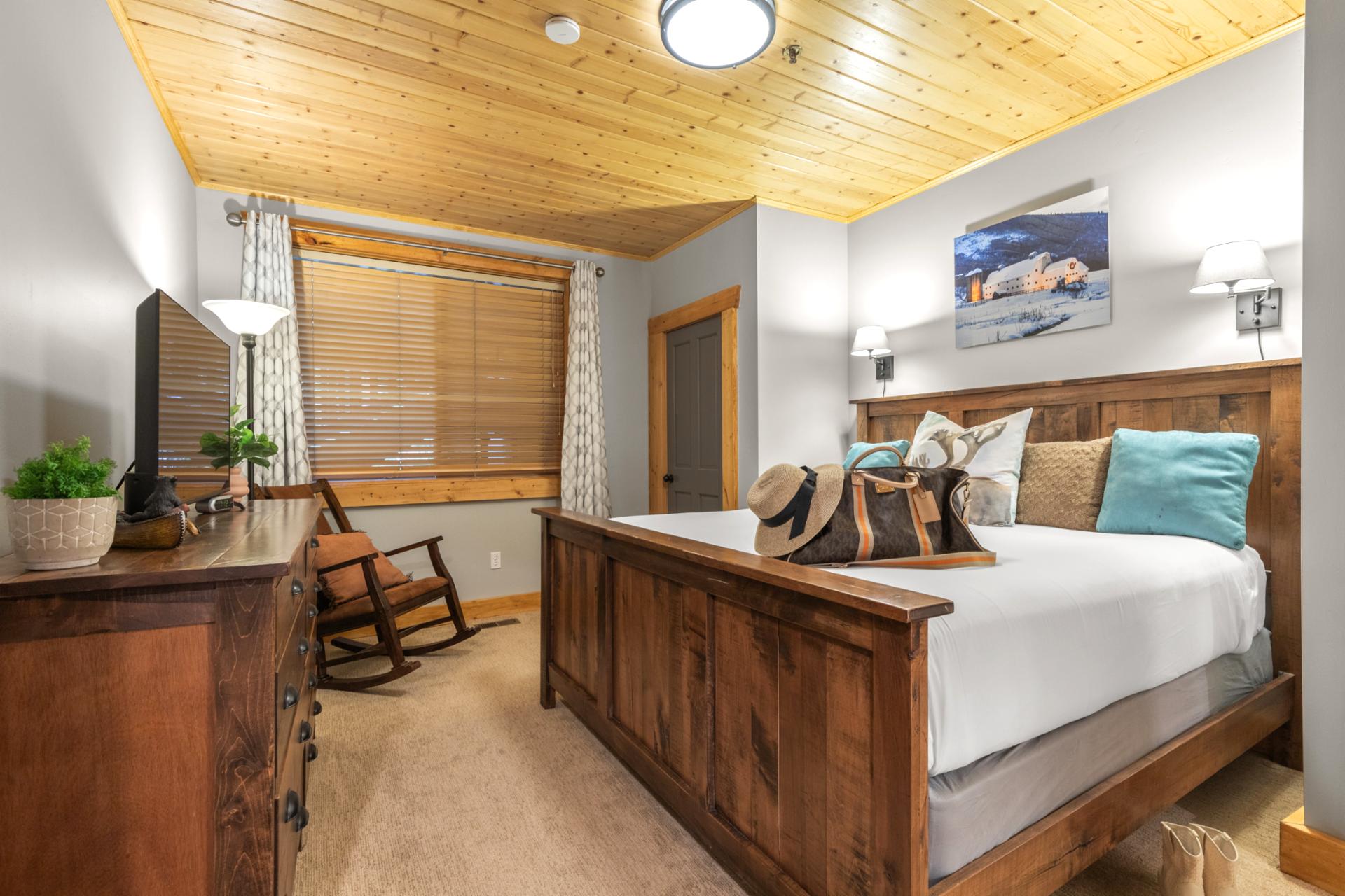 The primary bedroom includes a King bed, flat-screen TV, and direct access to a private bath.