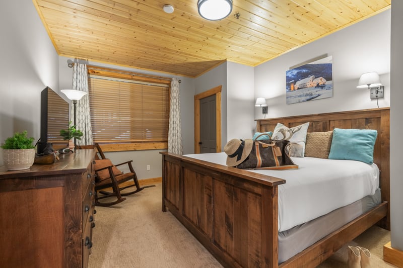 The primary bedroom includes a King bed, flat-screen TV, and direct access to a private bath.