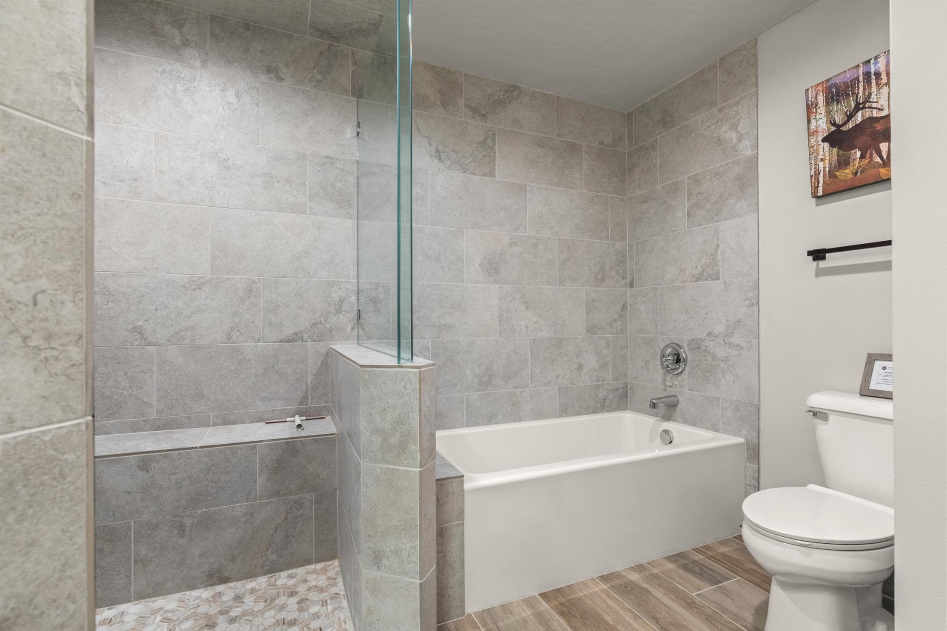 Walk-in shower and sleek finishes make this primary bathroom feel modern and spacious.