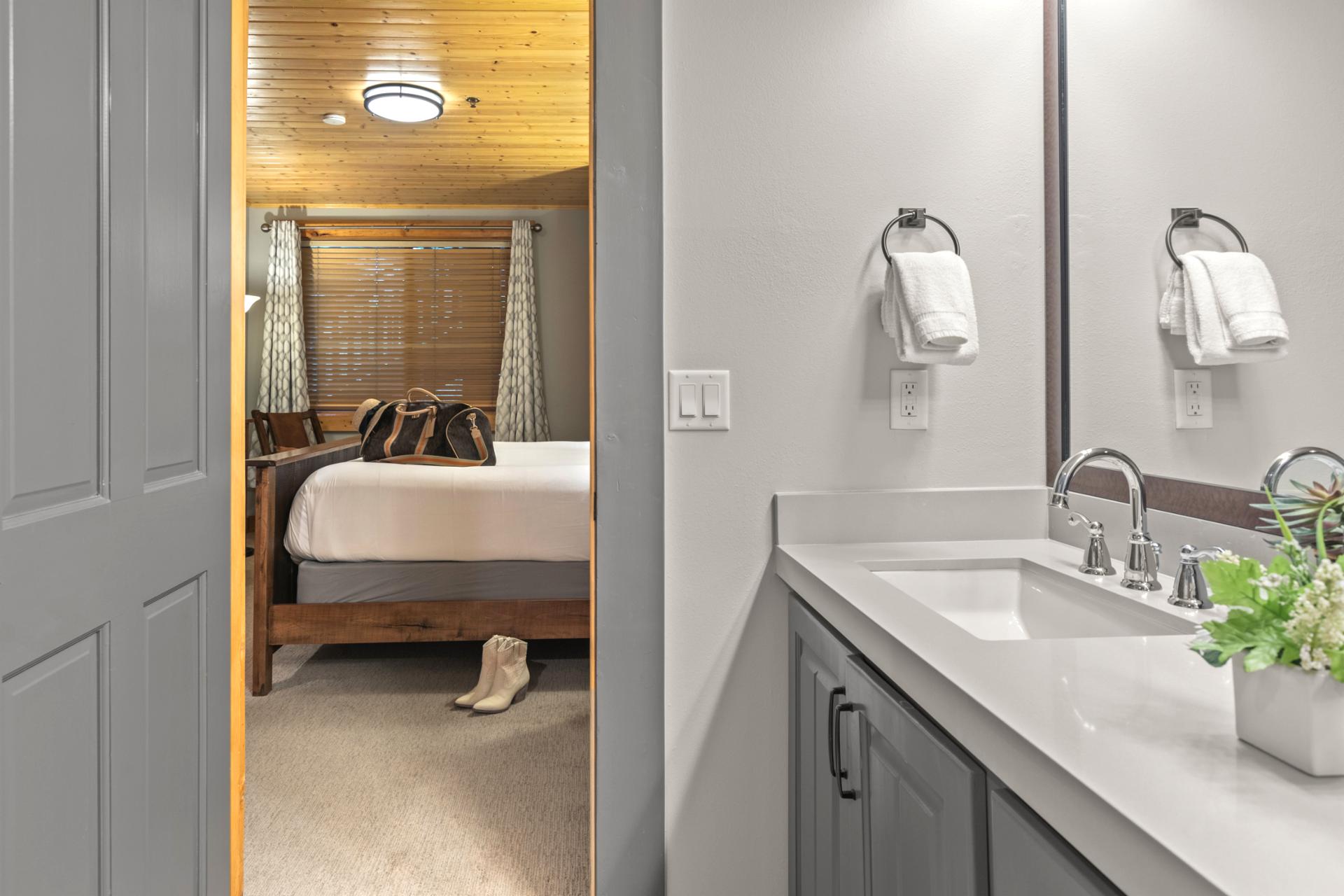 Your primary bath includes a vanity and walk-in shower with elegant tilework.