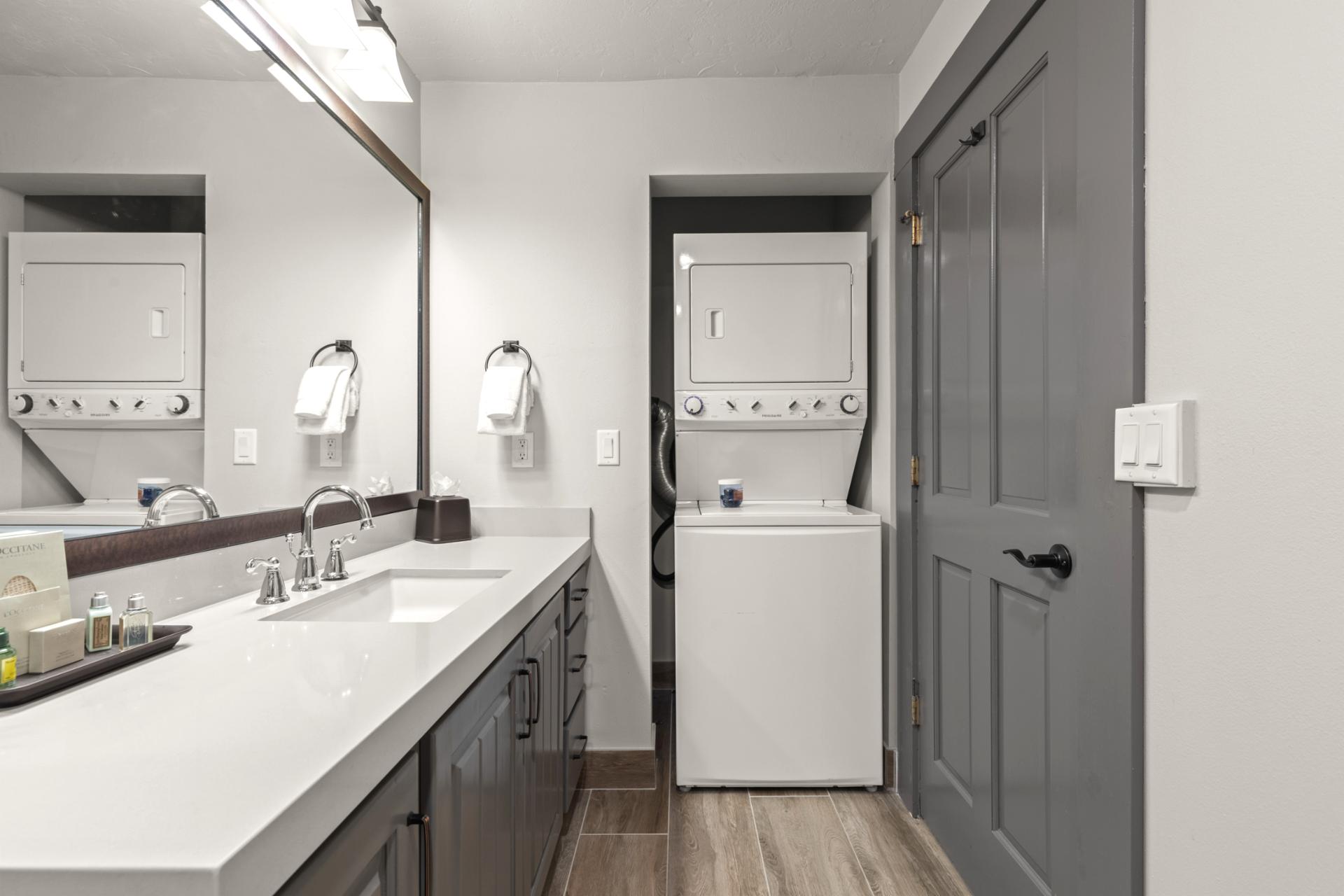 Clean and modern, the guest bath includes granite finishes and a spacious layout.