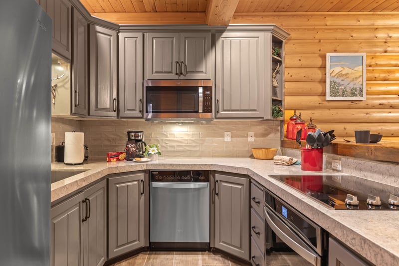 This fully equipped kitchen features granite countertops, appliances, and bar seating for casual meals and snacks.