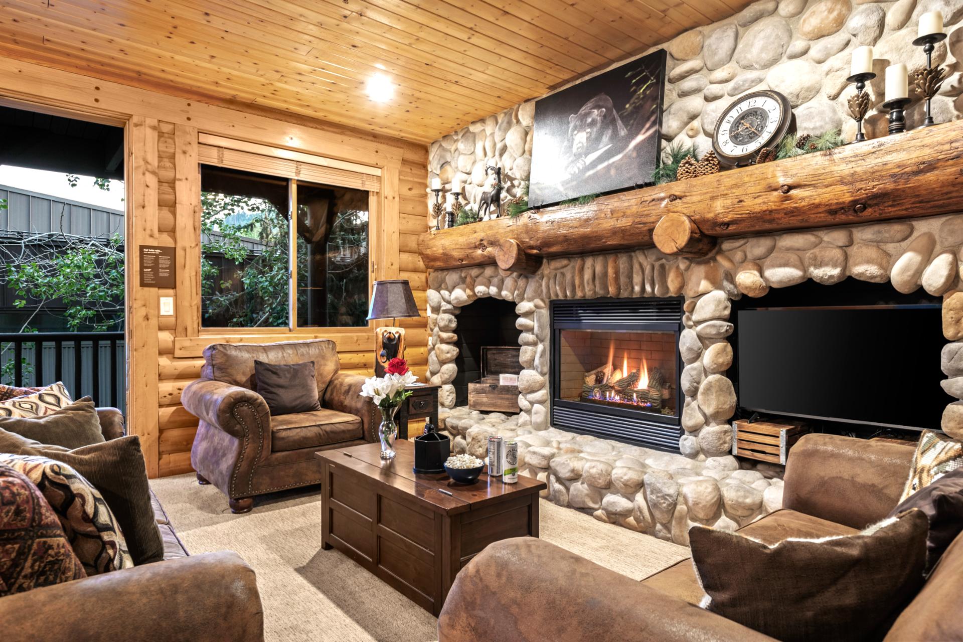 Mountain charm shines in this warm living space with exposed wood and inviting textures.