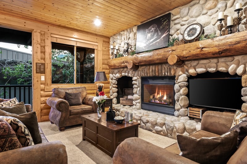 Mountain charm shines in this warm living space with exposed wood and inviting textures.