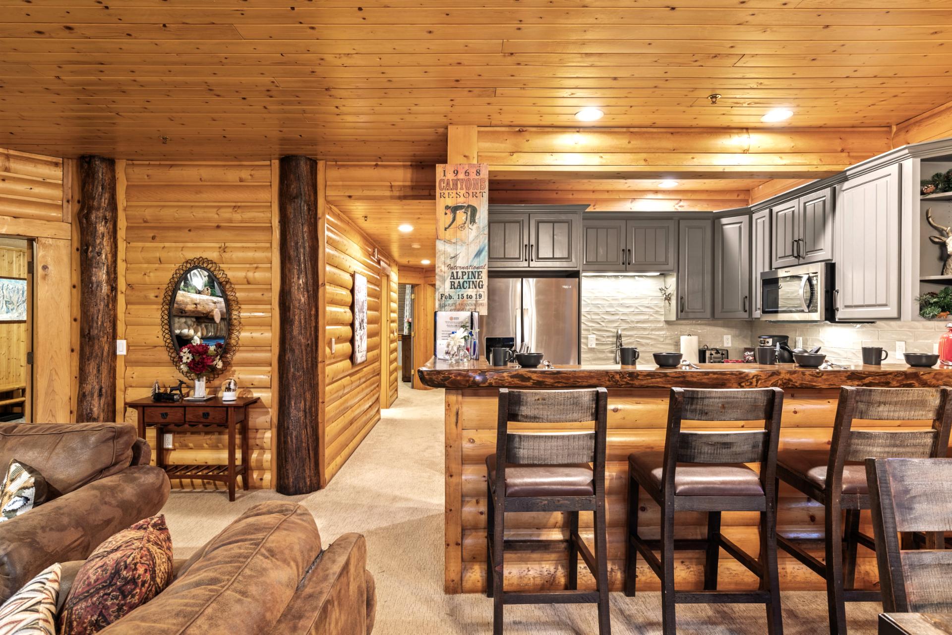 Warm wood paneling and a spacious layout make this home feel both rustic and refined.
