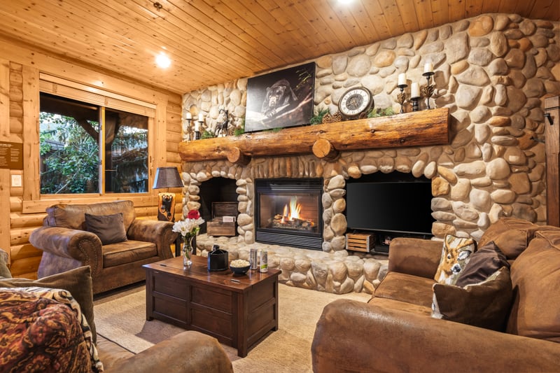 Your living room offers lodge-style comfort with a stone fireplace, flat-screen TV, and plenty of plush seating for movie nights or game days.