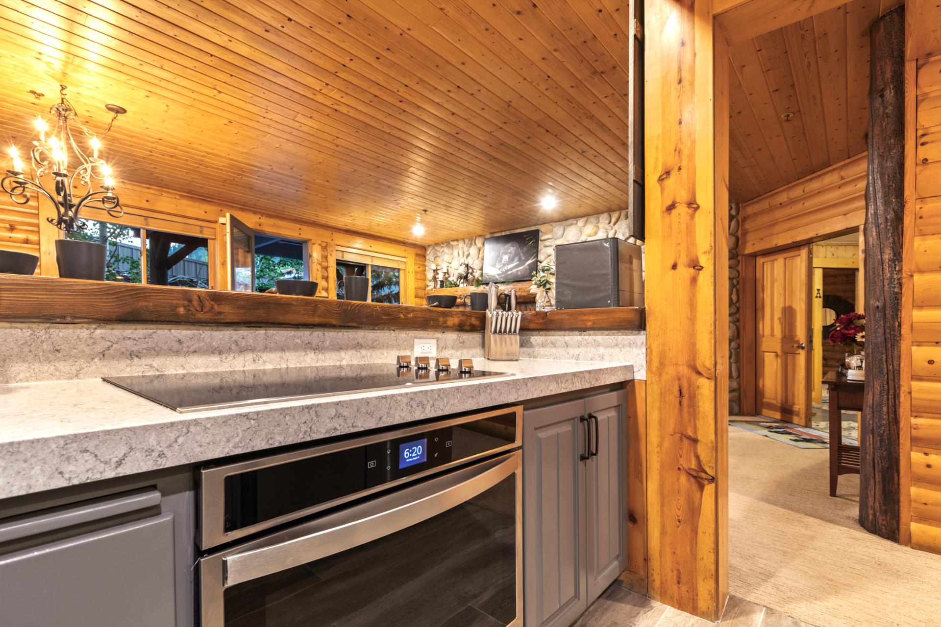 Granite counters, full-size appliances, and sleek cabinetry make cooking and entertaining easy.